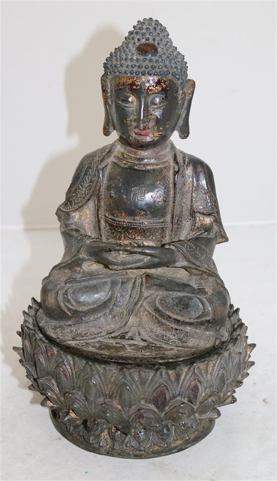 A Chinese lacquered bronze seated figure of Buddha Shakyamuni, Ming dynasty, 16th/17th century, height 28cm